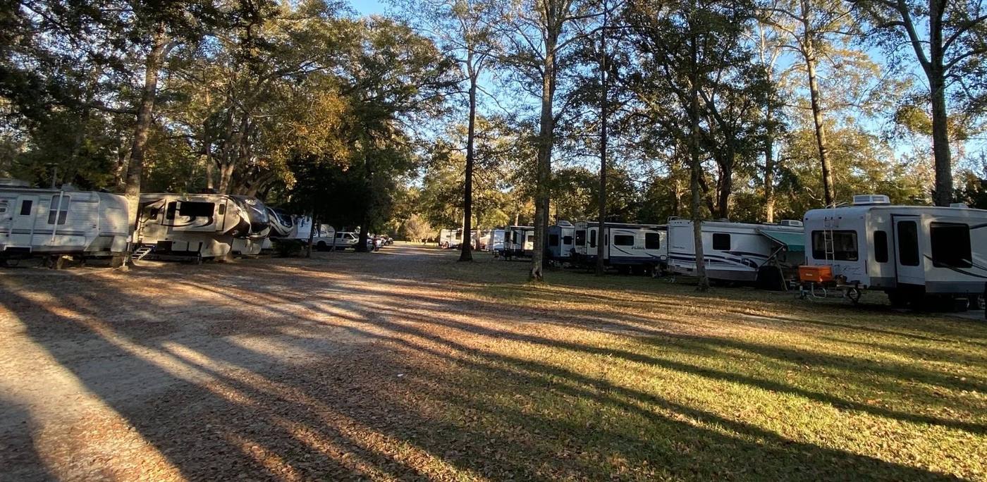 A row of RVs on large sites